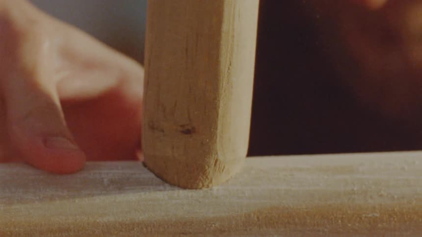 Wooden tool is pressed against a surface for carving