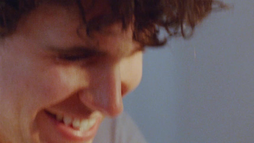 Man smiles in closeup with an expression of joy
