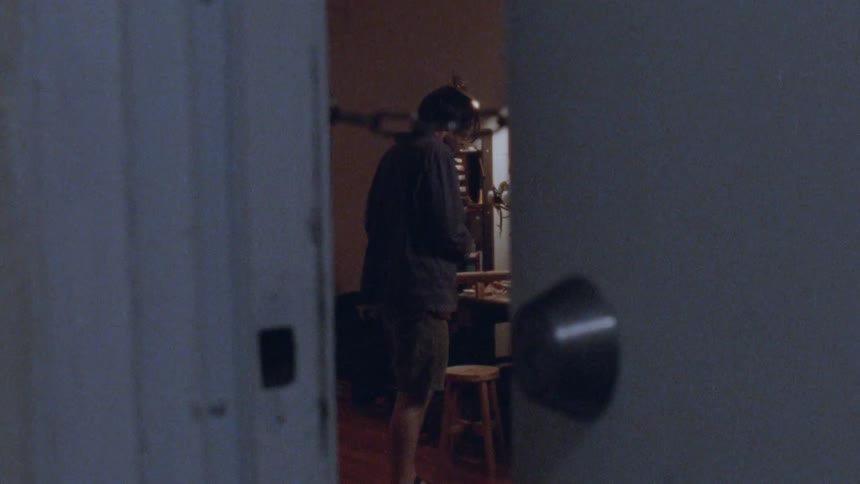 The door is pushed open and a nervous man paces inside