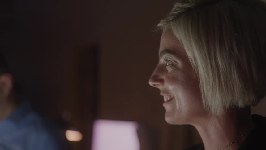 Blonde woman with short hair smiling indoors