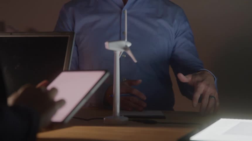 Miniature wind turbine on the table during a work meeting