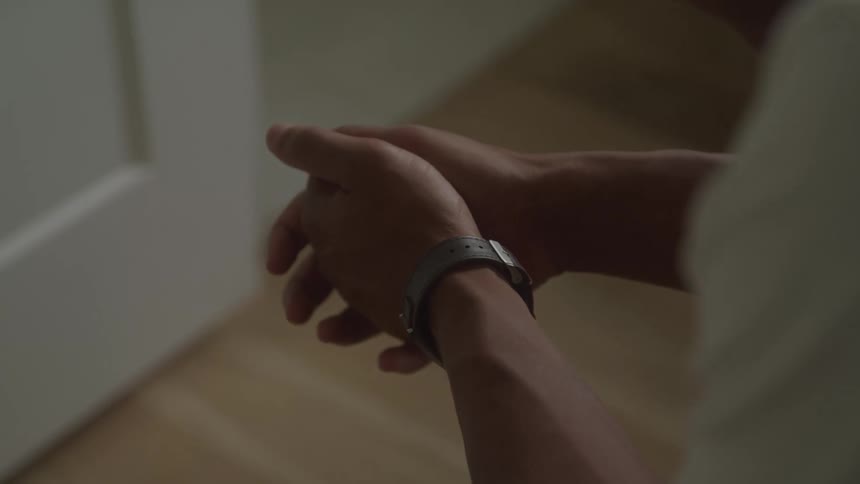 A very close view shows a persons hands clasped together