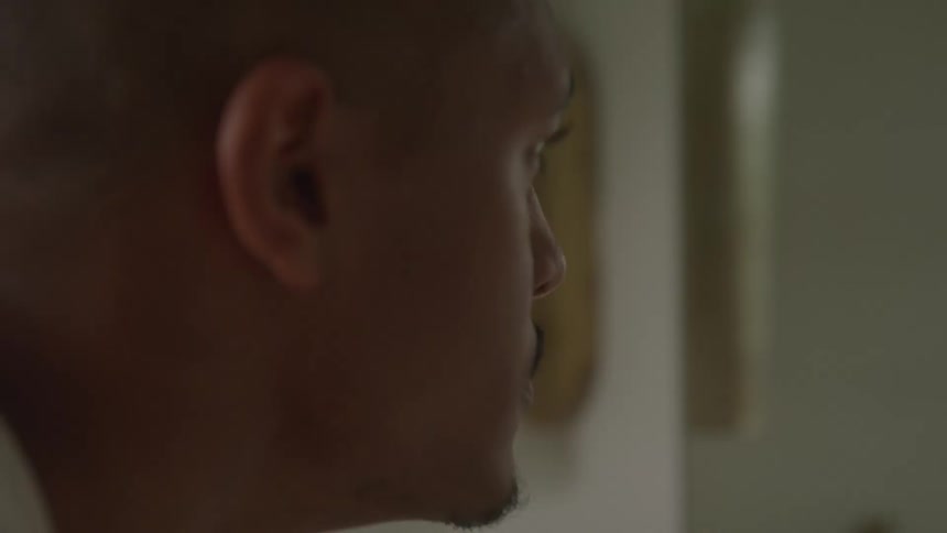 A sad man slowly lifts up his head