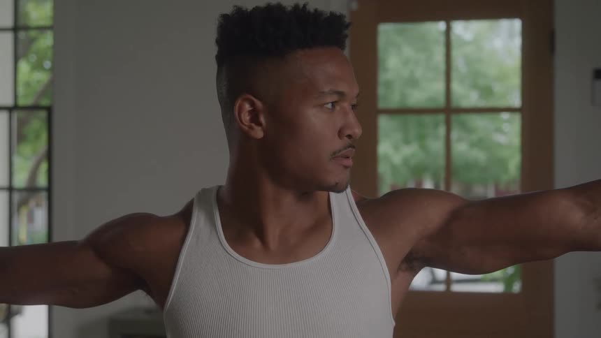 A man stretching with his arms extended