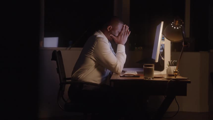 The man is working in the office at night