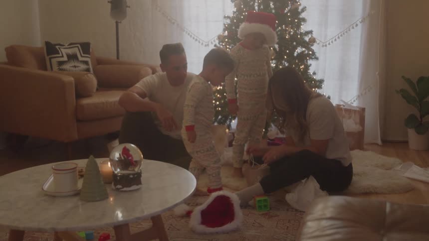 Family gathered in the living room in a christmas atmosphere around the decorated tree