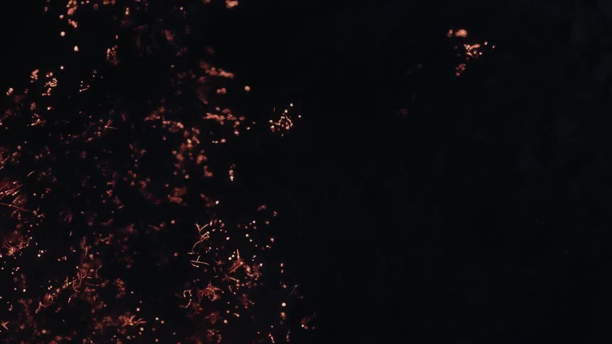 A orange color moves across a black background