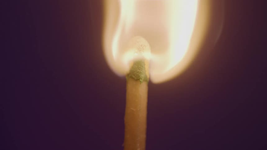 Lit matchstick burning with a strong flame