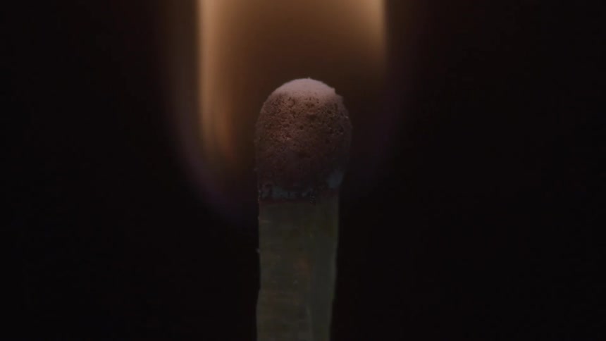 A close static view shows a red tipped matchstick with an orange flame that quickly burns out leaving the end black