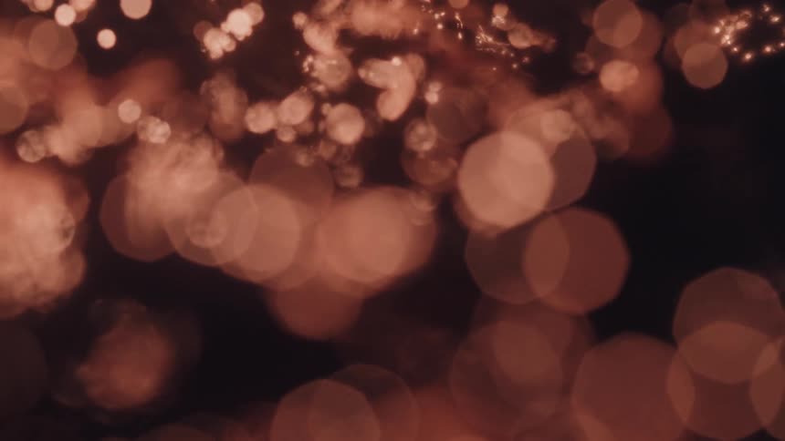Defocused reflections of orange lights create a bokeh effect