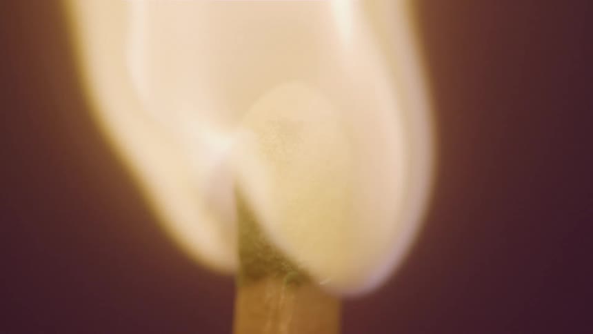 Based on the video a closeup shot shows the head of a matchstick igniting and burning the flame grows larger and brighter as it consumes the tip of the match