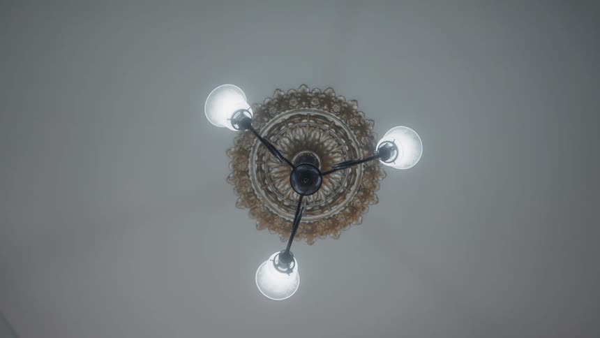 Vintage ornate ceiling light fixture flickering on and off