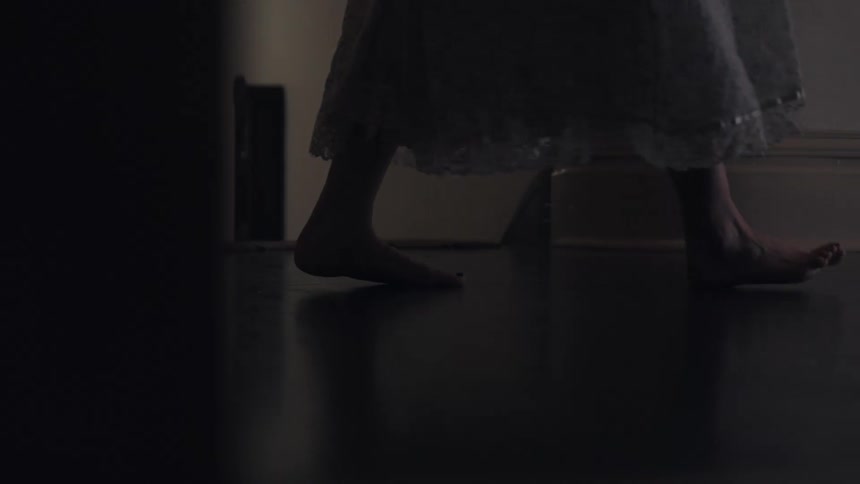 Person in dress walking barefoot