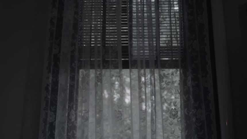 The wind blows the curtain on the window