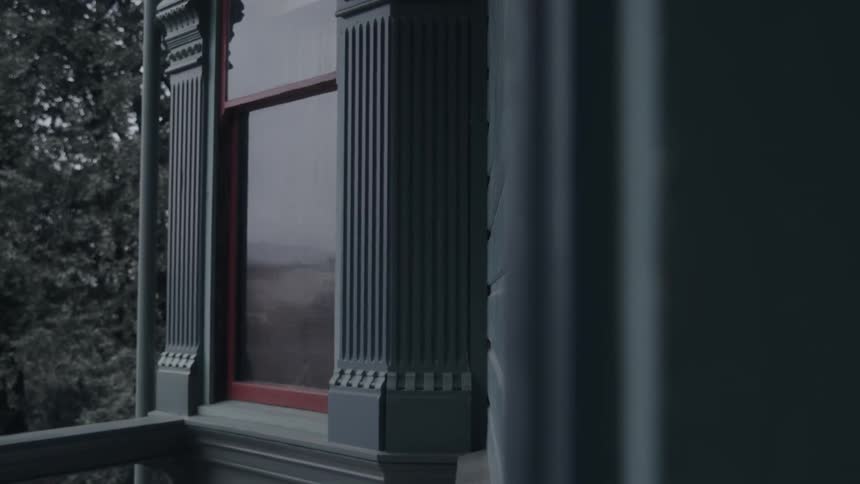 Red window framed by gray architectural details