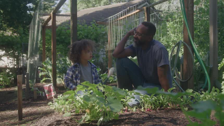 Father and son spend time together in the garden