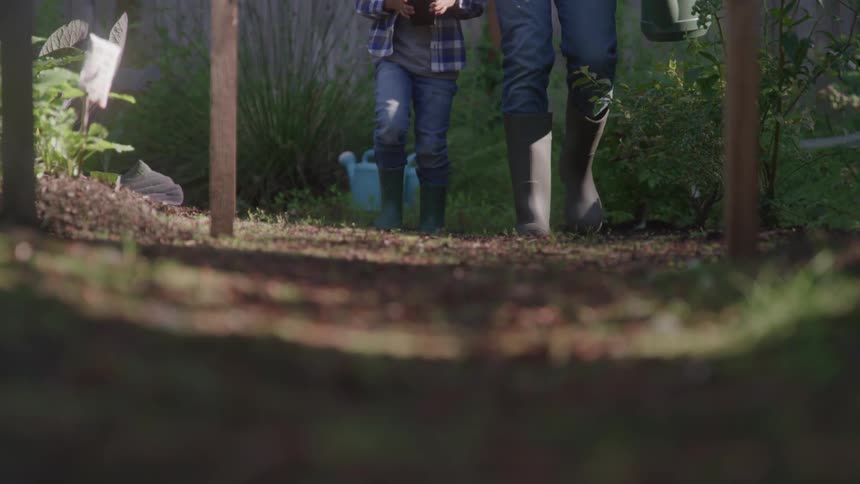 A parent and child walk through the garden