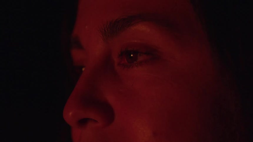 Face lit by the fires glow highlights a thoughtful and attentive gaze