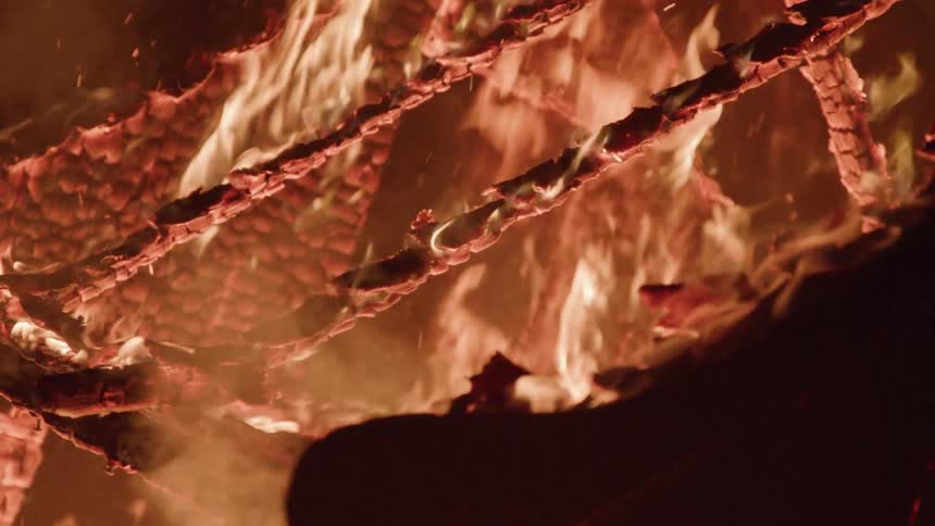 Structure of a house engulfed in flames at night