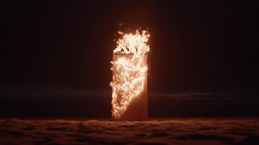 The structure is burning on the sand