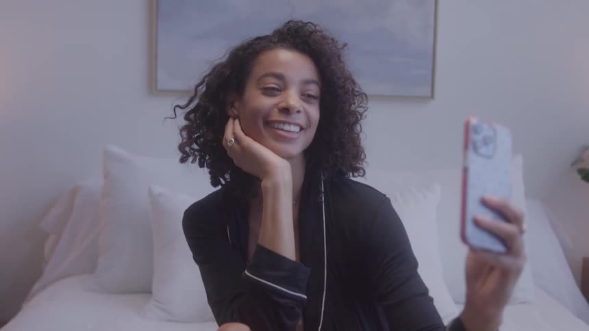 Woman smiling while making a video call on her phone
