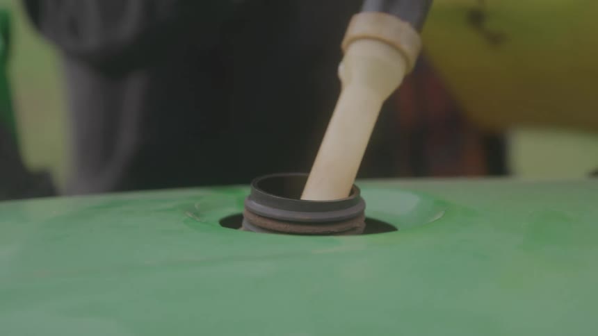 A man fills the machine with gas