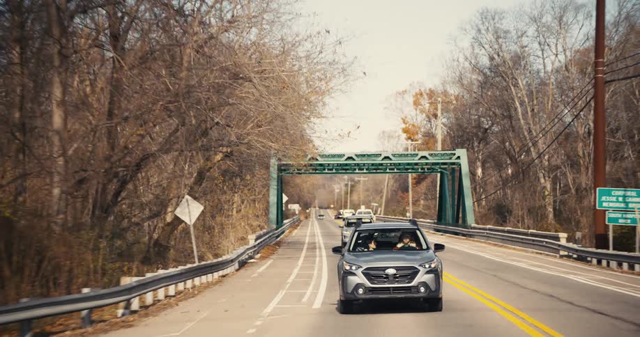 The video shows a firstperson view from a vehicle driving down a twolane road in a rural setting a gray suv is driving in the opposite direction and passes the camera