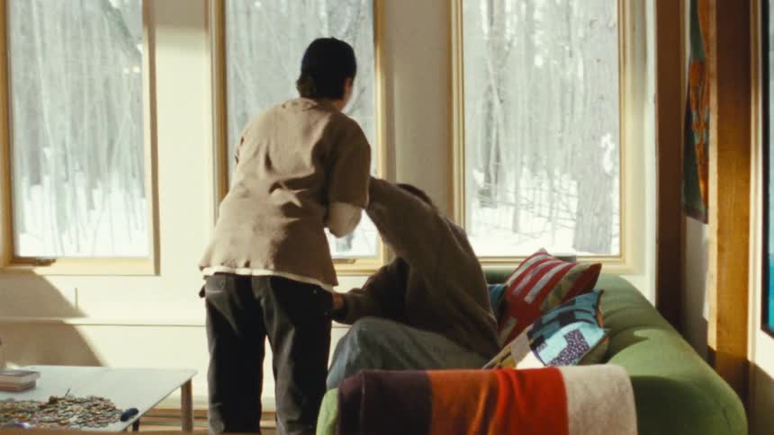 A lesbian couple shares an intimate moment indoors