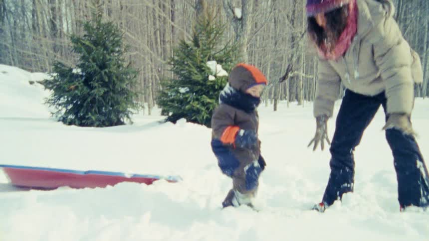 The family are playing in the white snow