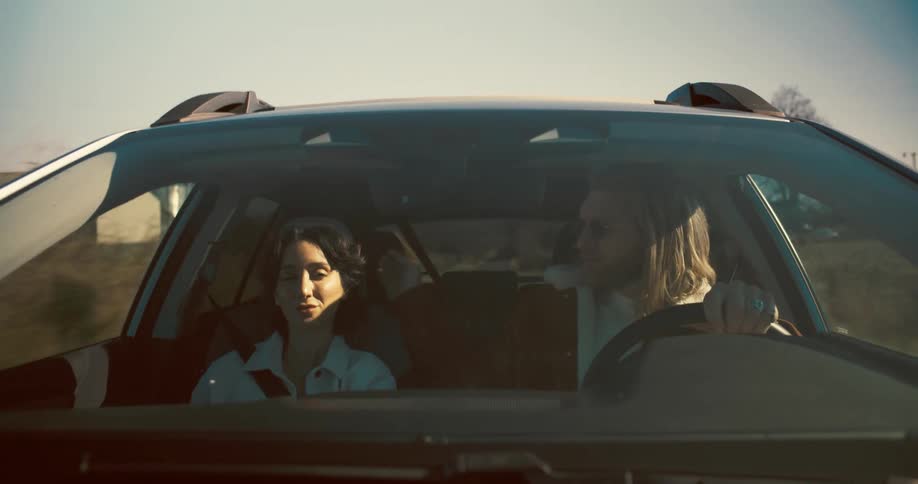 Couple travels by car enjoying the ride on a sunny day