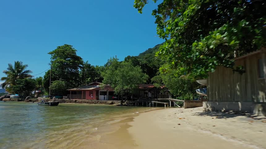 The tropical island is lined with small homes