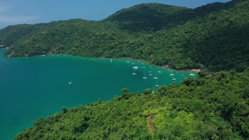 The island has many boats anchored along the shore
