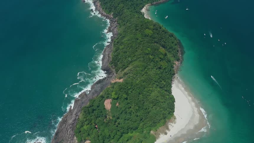 Aerial view of a lush green island surrounded by turquoise ocean waters