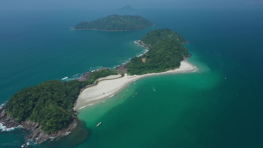 Aerial of a beautiful small remote island with white sand beaches and lush trees
