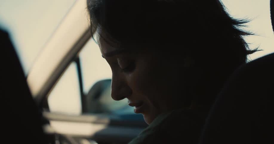 The sad woman talks in the car