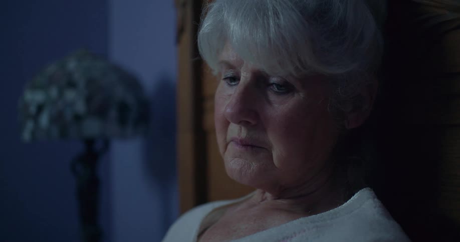 Lady sitting in a room of the house thinking