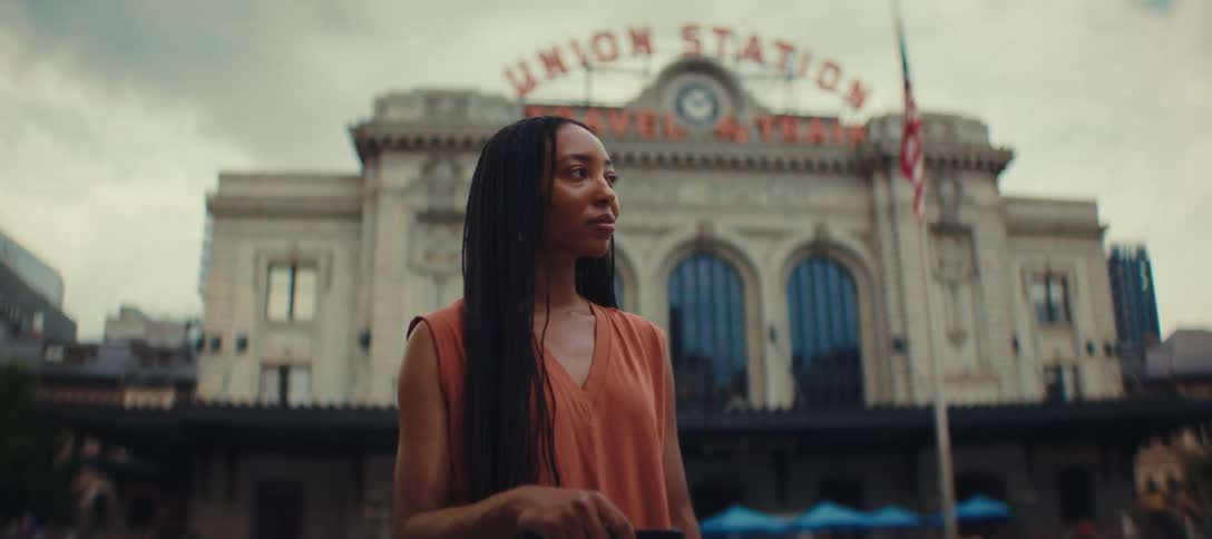Woman with suitcase looks at the facade of union station