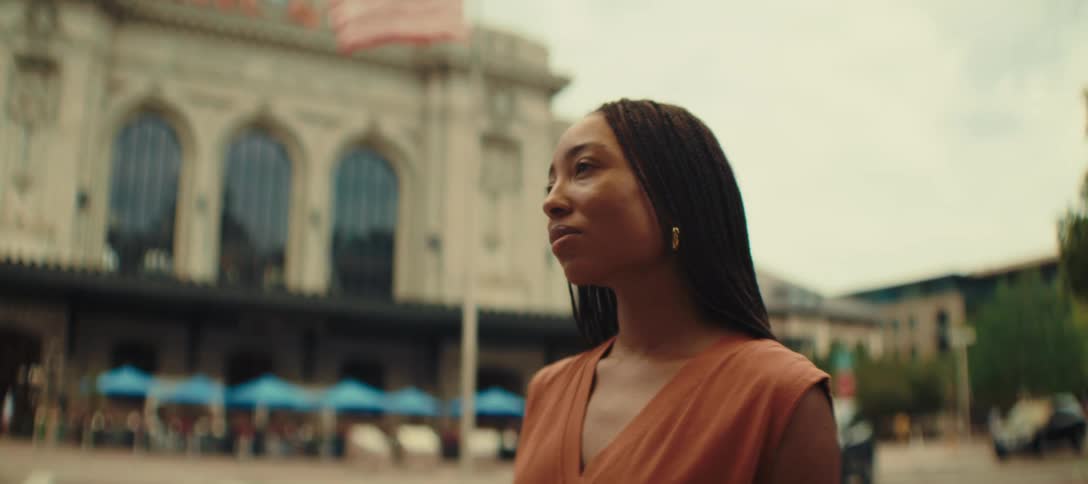 The woman is looking around the city