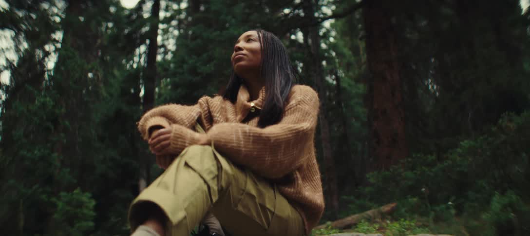 Woman sitting and enjoying nature in a forest area