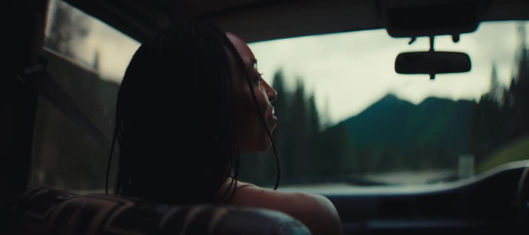 The woman laughs and talks while riding in the car