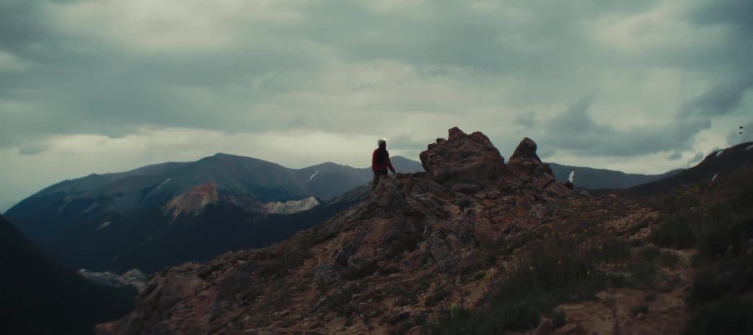 Person walking along a rocky trail on the mountain top