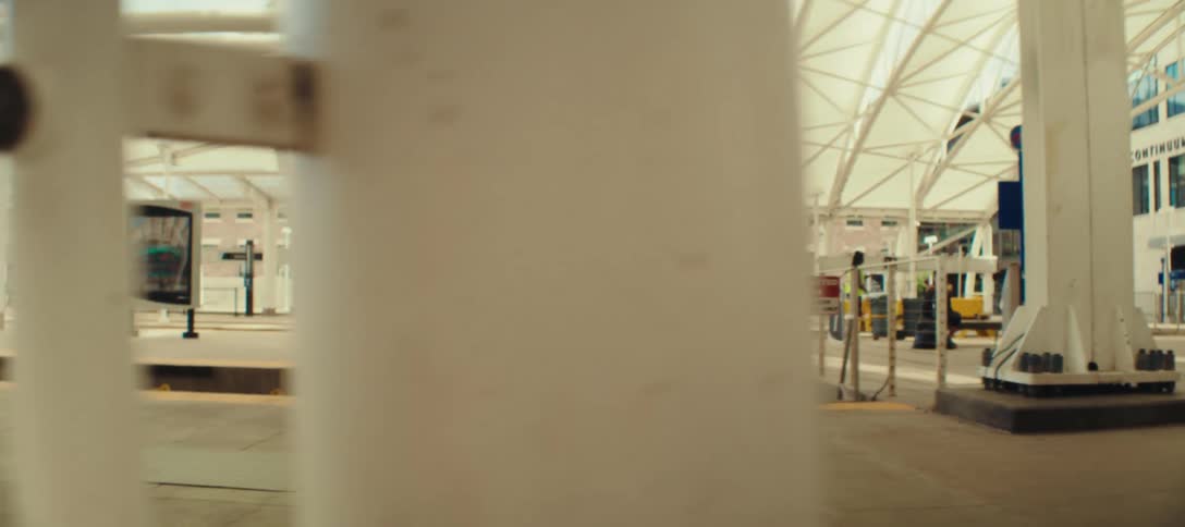 Woman walking through the station with a rolling suitcase
