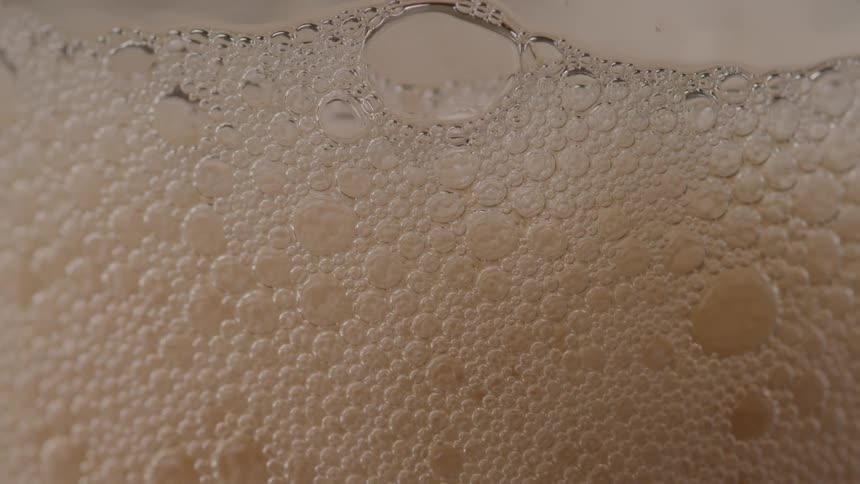 The foam is at the top of the beer