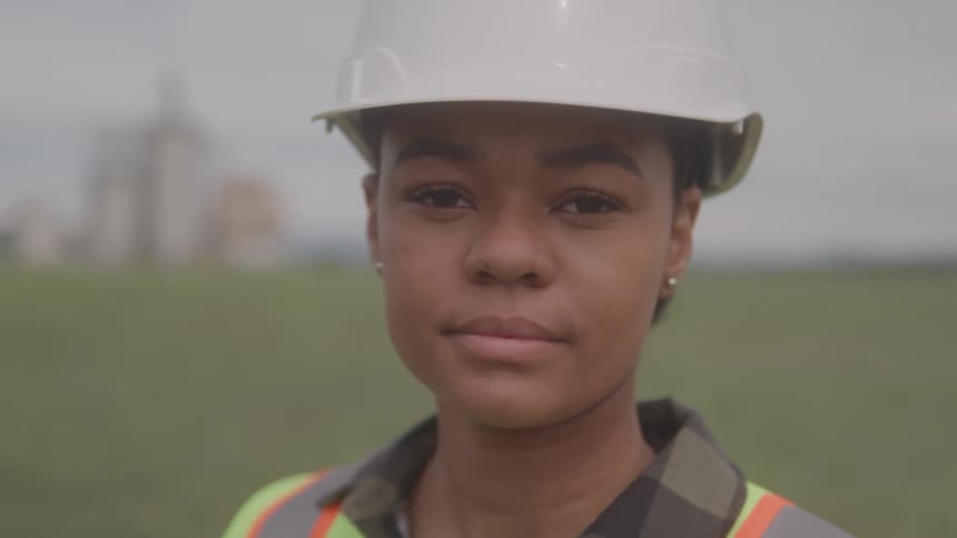 Woman wearing a safety helmet and reflective vest