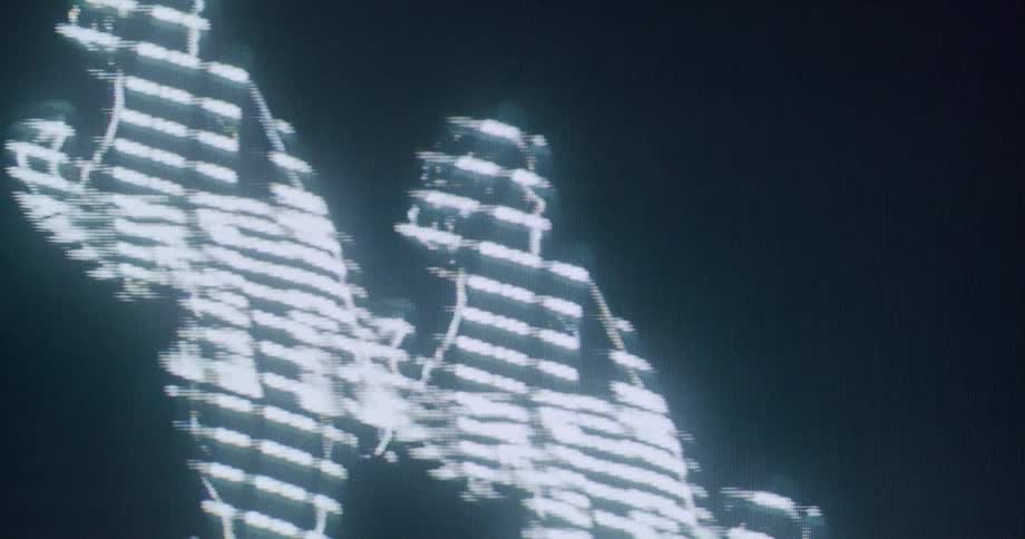 Human silhouettes illuminated by white light streaks appear against a dark background