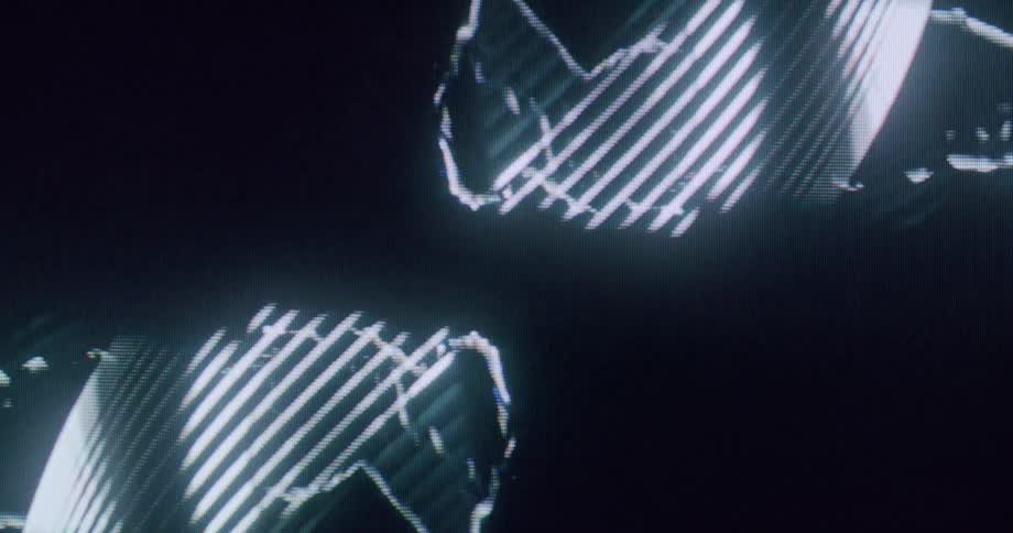 The screen displays a hologram of two women passing each other dancing