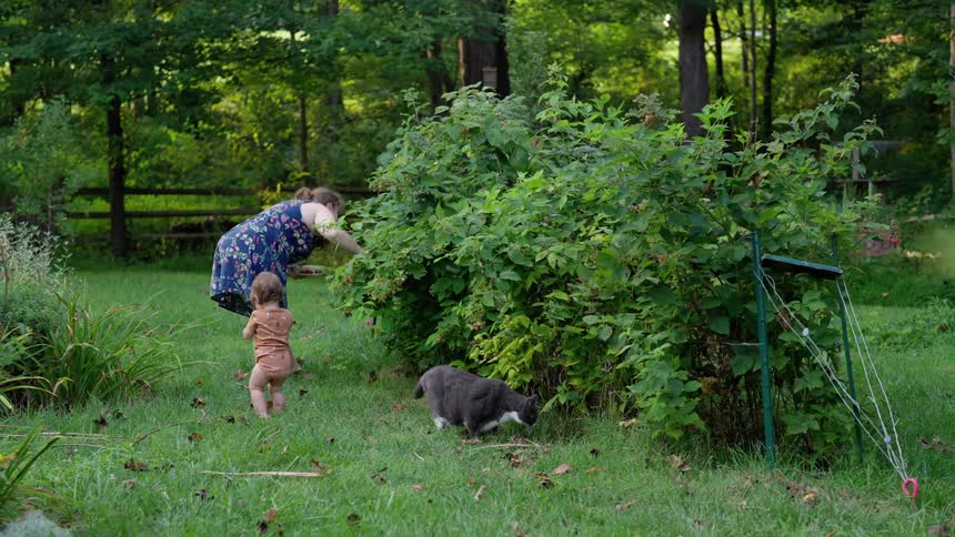 A woman and child spend time outdoors in a garden