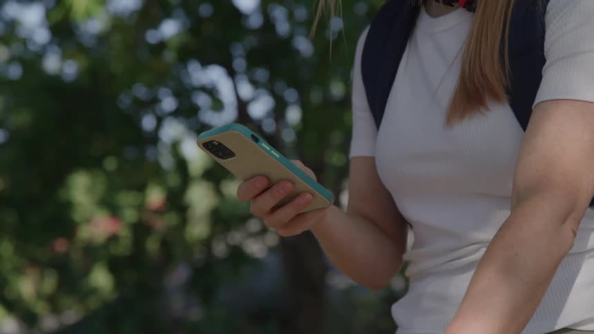 A woman is texting while on her bicycle