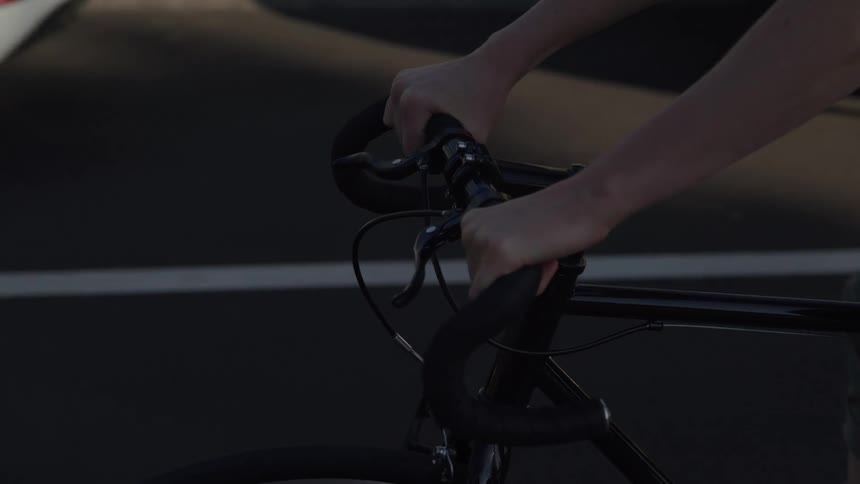 A person is riding their bicycle on the road during the day