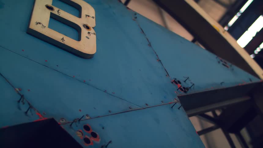 Closeup of a blue metallic star with the white letter b attached to its surface